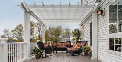 Gorgeous deck with white pergola and deck furniture